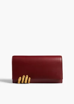 Khaite Evening-Sculpted Hand Clutch in Oxblood Leather