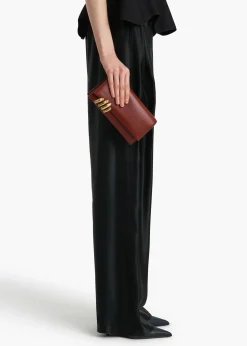 Khaite Evening-Sculpted Hand Clutch in Oxblood Leather